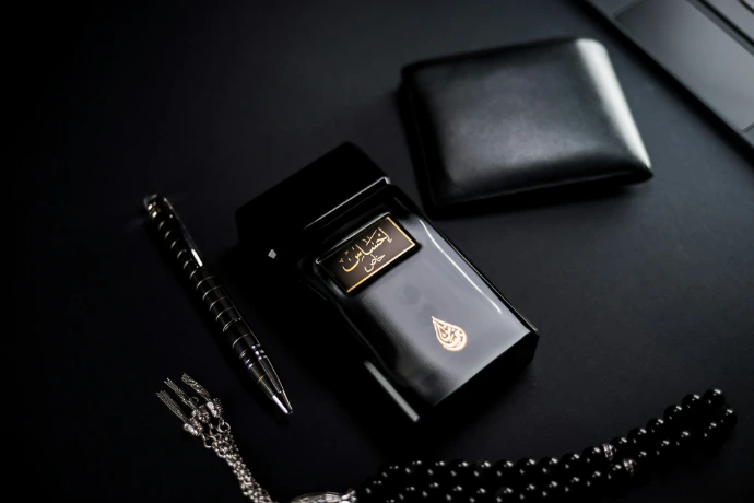 black leather bifold wallet beside silver and gold watch
